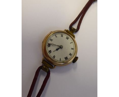 A lady's early 20th century 9-carat gold-cased wristwatch; cream-enamel dial with Roman numerals and blued-steel hands, Swiss