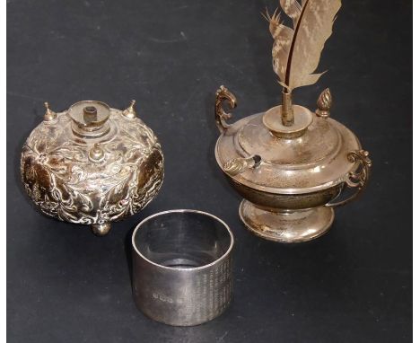 A late 19th century white-metal table lighter of squat spherical form; decorated in low relief with leaves, tendrils and vign