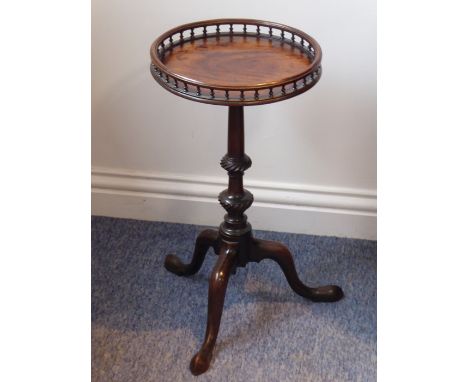 A small George III style circular mahogany kettle stand; the galleried balustrade top above turned stem and on tripod base te