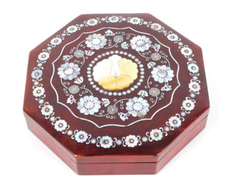 An Asian lacquer and mother of pearl and shell inlaid octagonal box and cover, inlaid with flowers and Chinese seals, fitted 
