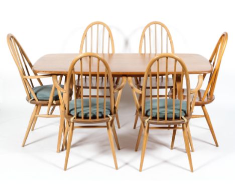 An Ercol blonde elm and beech rectangular dining table, five Quaker carver chairs and one chair, three with blue cushions, th