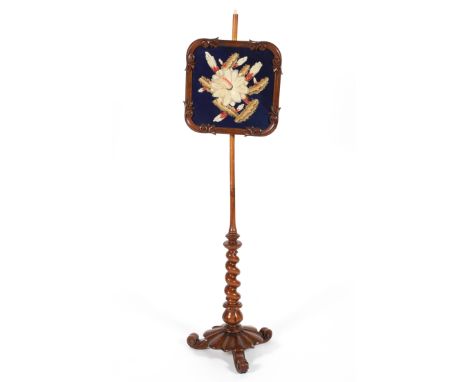 A Victorian walnut pole screen circa 1860, on barley twist stem, the screen with floral tapestry insert within foliate and sc