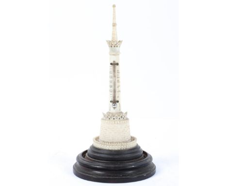 An Anglo Indian carved ivory thermometer, circa 1890, of column form with engine turned base and pierced collar, on turned eb