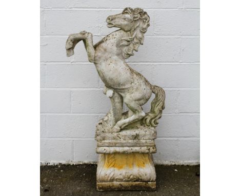 Garden Statuary: a cast stone figure of a rearing horse, on a stepped plinth with foliate corners, 144cm high