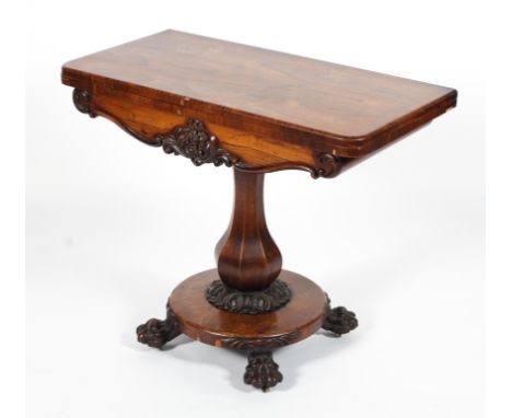 A Victorian rosewood folding card table, with D-shaped swivel top, inset with red baize top, the apron carved with foliate ap