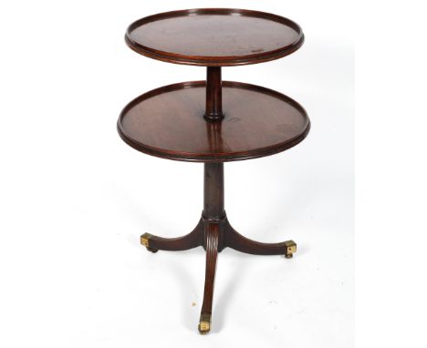 A Georgian two tier dumb waiter, the graduated circular tiers with raised edges on a tripod base, 81cm high x 60cm