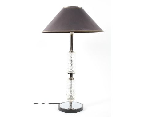 A mid century style glass and chrome table lamp with black shade, circa 1960, with reeded column divided by two faceted glass