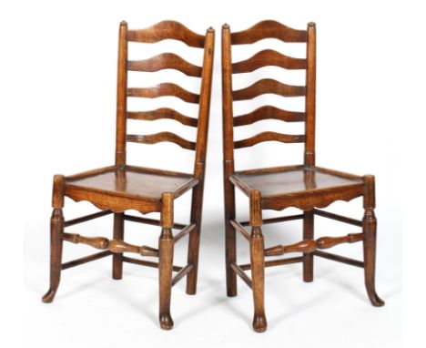 A pair of elm kitchen chairs, with ladder backs and plain seats, on rounded legs, 99.5 cm high