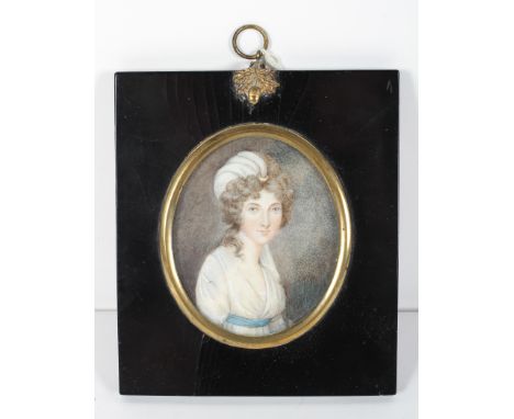 A portrait miniature of a young lady, early 19th century, wearing a muslin dress with blue sash, in gilt metal and ebonised f