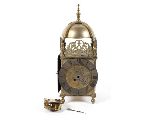 A brass lantern clock, of traditional form with pierced foliate ornament, the movement loose, the face engraved with scrollin