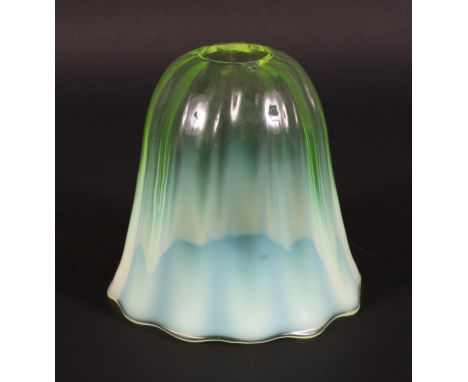 A vaseline glass lamp shade, circa 1900, of tapering lobed form and graduated yellow tint, 12 cm wide 
