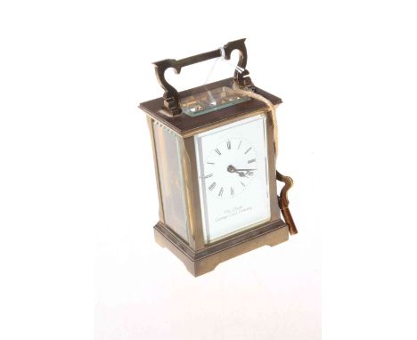 Gilt brass 'The Chester Carriage Clock Company' clock with bevelled glass panels.