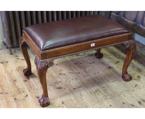 Chippendale style mahogany and leather stool on ball and claw legs.