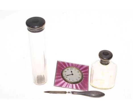Silver and pink enamel clock, two silver topped toilet bottles and nail file (4).