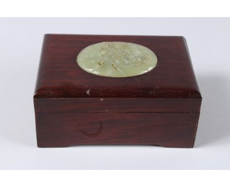 A CHINESE WOODEN BOX, the lid with a carved oval jade plaque. Jade 2.75ins x 2ins.