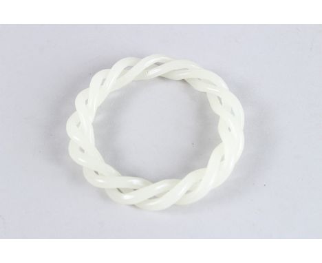 A CHINESE WHITE JADE ARTICULATED BANGLE. 3.5ins diameter.