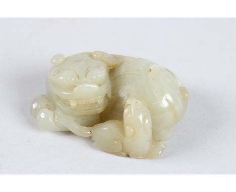 A FINELY CARVED 19TH - 20TH CENTURY CHINESE JADE CARVING OF A LION. 2.5ins diameter.