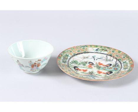 A CHINESE FAMILLE ROSE CIRCULAR BOWL, 4ins diameter, and a cock fighting plate, 7ins diameter (2).