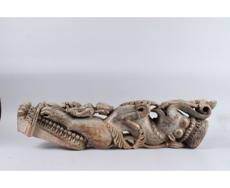 A LARGE 18TH - 19TH CENTURY SOUTH INDIAN CARVED WOODEN ARCHITECTURAL ELEMENT IN THE FORM OF A YALI. 34ins long. 7ins x 4.5ins
