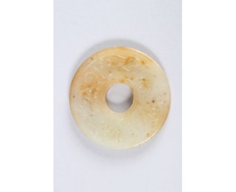A SMALL CHINESE CARVED JADE BI DISC. 2ins diameter.