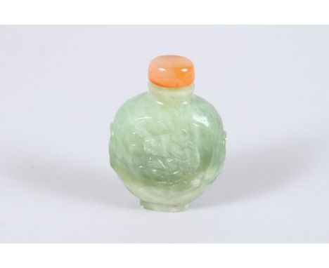 A CHINESE TWO COLOUR JADE SNUFF BOTTLE AND STOPPER, carved with dragons. 2.5ins high.