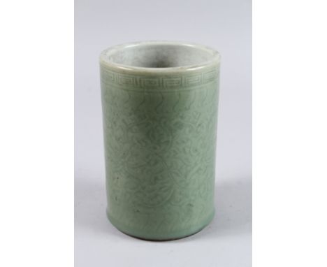 A CHINESE GREEN PORCELAIN BRUSH POT. 7ins high.