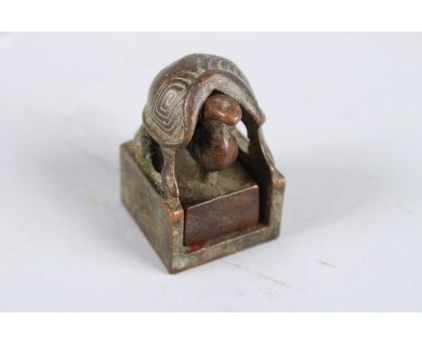 A CHINESE GROUP BRONZE SEAL.