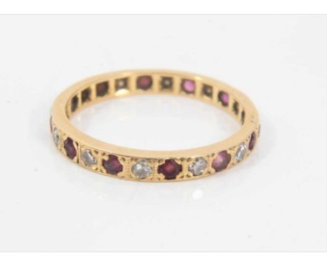 Ruby and diamond eternity ring with a full band of single cut diamonds alternating with round mixed cut rubies in yellow gold