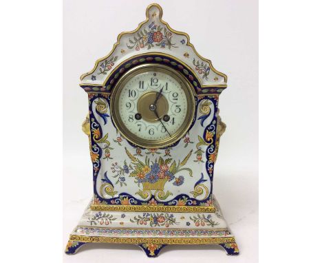 Late 19th century French Faience cased mantel clock with painted floral decoration and lions head ring handles, French moveme