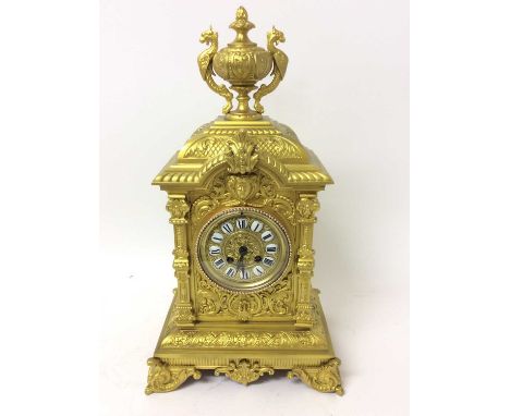 Impressive late 19th century gilt metal mantel clock with cast urn mount, human mask and floral scroll decoration, French mov