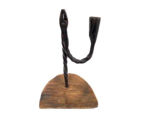 18th century wrought iron nip rush light holder, with candle socket arm raised on diagonally sawn fruitwood base, 23cm high
