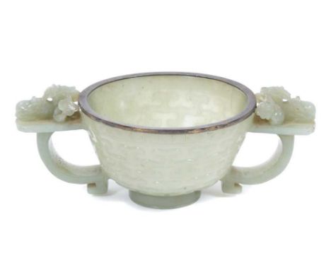 Good Chinese carved jade two handled bowl, probably 18th century, of celadon tone, hemispherical form with silver rim and str