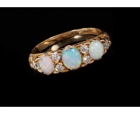 Victorian style opal and diamond ring with three cabochon opals and six old cut diamonds in carved gold setting. Ring size L½