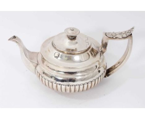 George III silver teapot of circular form, with half fluted decoration, engraved armorial crest, hinged domed cover and angul