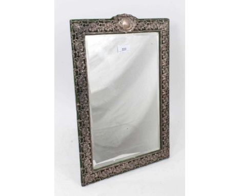 Early George V Silver mounted dressing table mirror of vertical rectangular form, with embossed and pierced floral decoration