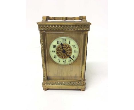 Edwardian brass carriage clock with enamelled dial 14.5 cm high, key present