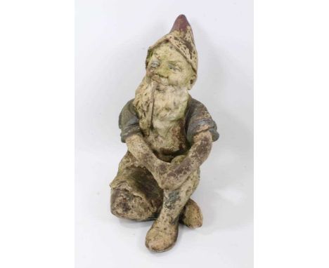 Antique terracotta garden gnome, traditional form, seated smoking a pipe, 61cm highCondition report: This is ceramic though m