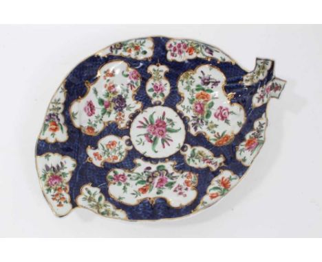 Worcester cabbage leaf dish, circa 1770, painted with panels of flowers with gilt scrollwork borders, on a blue scale ground,