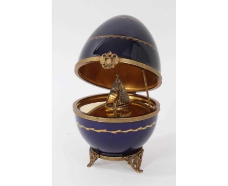 Limoges Faberge Easter egg, the cover hinged to reveal silver gilt interior with sailboat, signed Fabergé, numbered 84, with 