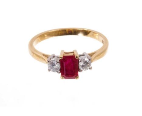 Ruby and diamond three stone ring with rectangular step cut cut ruby flanked by two brilliant cut diamonds in 18ct gold setti