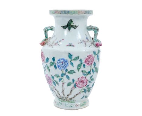 Chinese polychrome porcelain vase, 19th century, of baluster form with fruit and branch handles, decorated in relief with fol