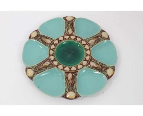 Victorian Minton Majolica oyster plate, decorated with light blue wells and a central green well, with shell decoration in re