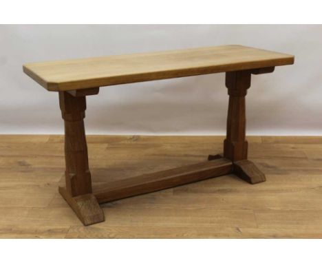 Manner of Robert 'Mouseman' Thompson of Kilburn, hardwood coffee table, rectangular canted top on facetted supports and H-sha