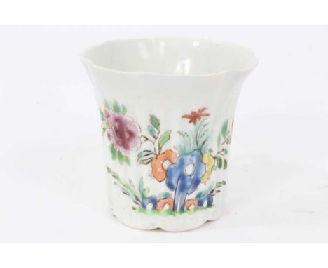 An early Worcester fluted coffee can, circa 1753-54, painted in Chinese famille rose style with flowers issuing from rockery,