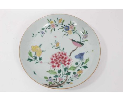Chinese famille rose saucer dish, Qianlong period, decorated with an exotic bird perched on a branch, surrounded by various f