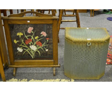 An oak hand-painted fire screen, c.1930; a 'Lloyd Loom' laundry basket (2)