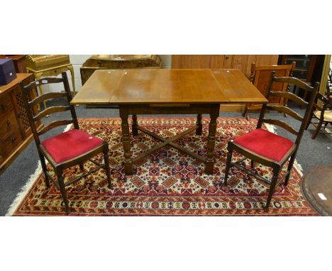 An early-20th Century oak draw leaf dining table, turned supports, X-frame structure; a pair of oak shaped ladder-back dining