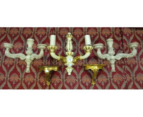 A pair of softwood wall sconces picked-out in gilt; a pair of gilded wall brackets; a two-arm cream and gilt wall light