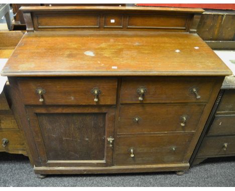 An early-20th Century oak sideboard, panelled superstructure, above four short drawers and a cupboard door, bun feet, c.1930;