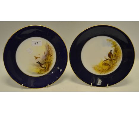 A pair of Royal Worcester plates, painted to centre with Mallards in Flight and Pheasant, signed C.Johnson
